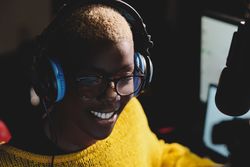 Smiling Black female radio host in studio