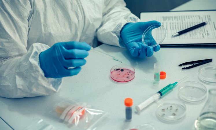 Scientist with a petri dish in the laboratory