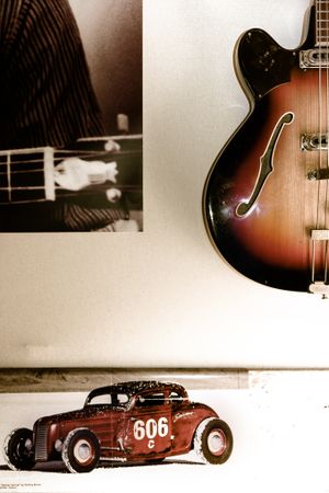 Vintage bass guitar and classic car poster on the way