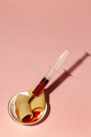 Stuffed pasta with red sauce in syringe