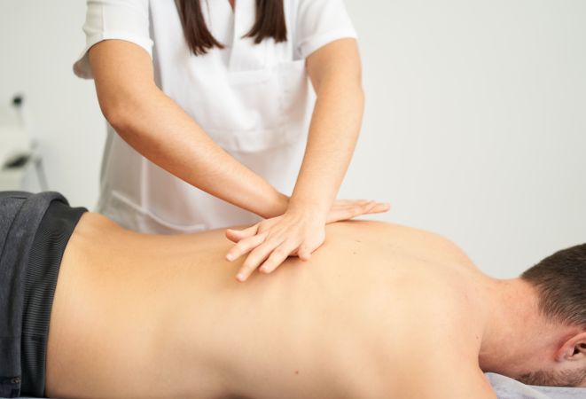 physiotherapist treating a contracture in the patient's back