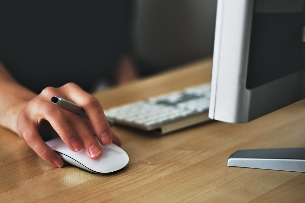 Cropped image of person using computer mouse