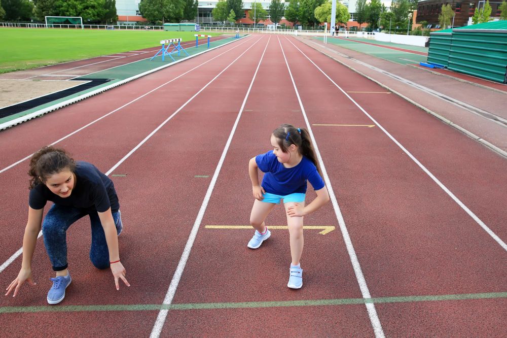 Two female siblings getting ready to race on track