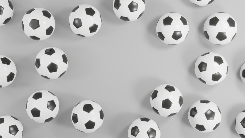 Sophisticated 3D footballs: Monochromatic soccer balls on a grey backdrop