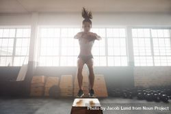 Shot of young woman working out with a box at the gym 5XOyG0