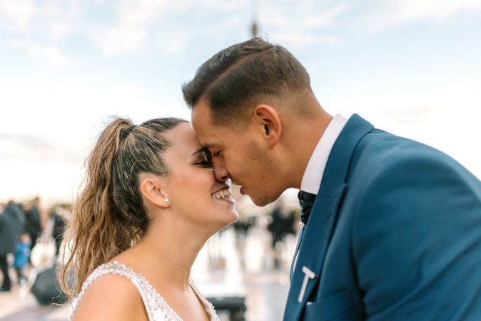 Happy newlyweds in wedding clothing kissing