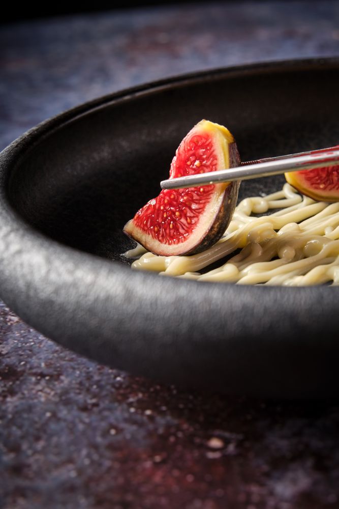 Fresh sliced fig in bowl at restaurant