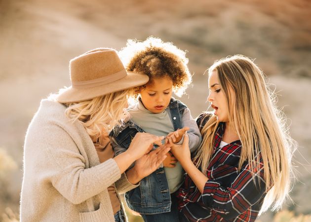 Smiling blond women walking with curly child