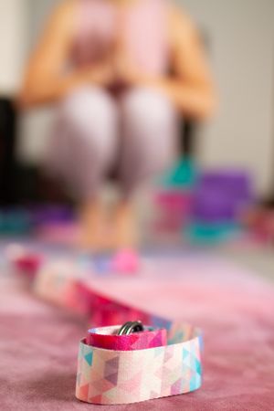 Closeup of colorful belt on yoga mat
