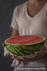 Cropped image of a person holding half a watermelon 5QXPg0