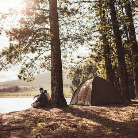 Shot of a mature couple camping in the woods