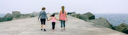 Back view of three female generations walking