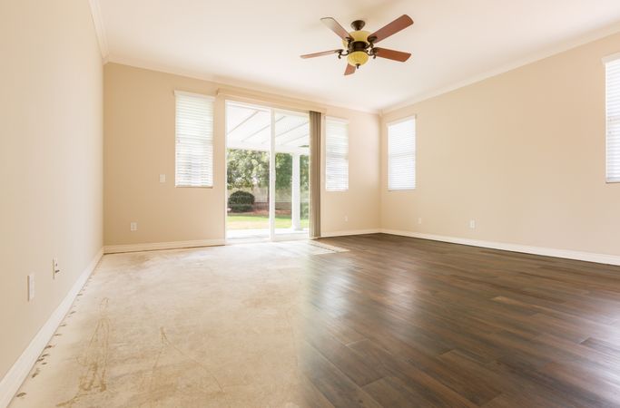 Room with Gradation from Cement to Hardwood Flooring