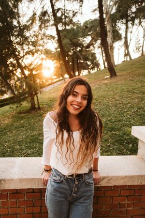 Cheerful young woman in park