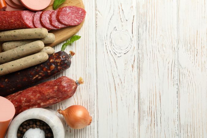 Selection of cured meats with wooden background, copy space