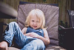 Girl sitting on armchair at home