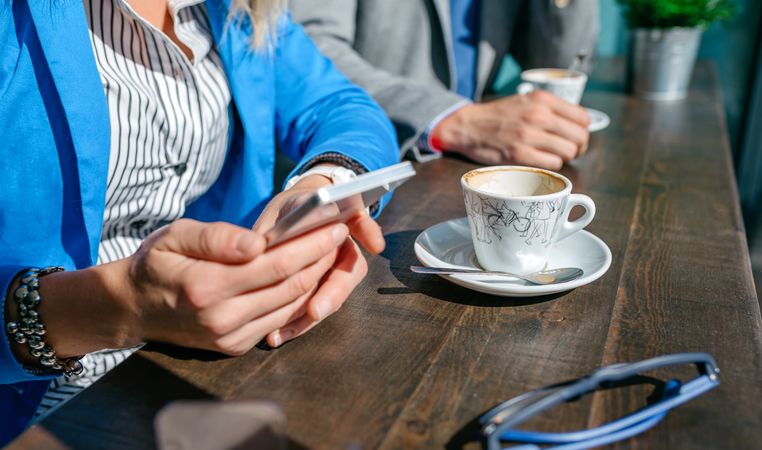 Hands of business woman and man having coffee