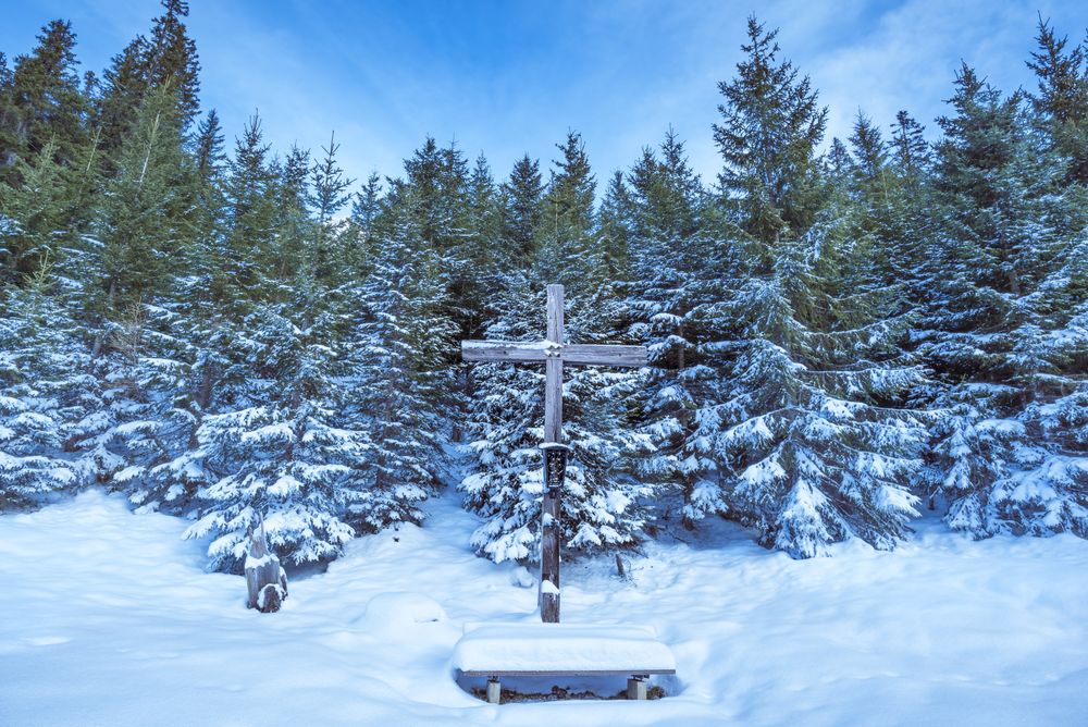 Wooden cross in winter scenery