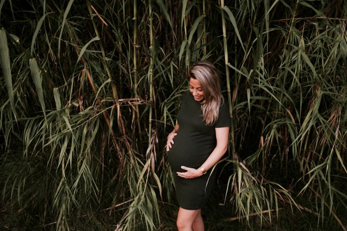 Pregnant woman standing in garden