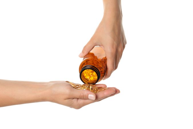 Brown bottle with omega pills, isolated on blank background