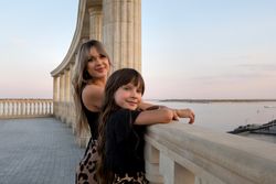 Mom and little daughter walk around city in evening