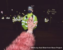 London, England, United Kingdom - March 16, 2021: Woman with tampon in hand in front of policemen 5aWQPb