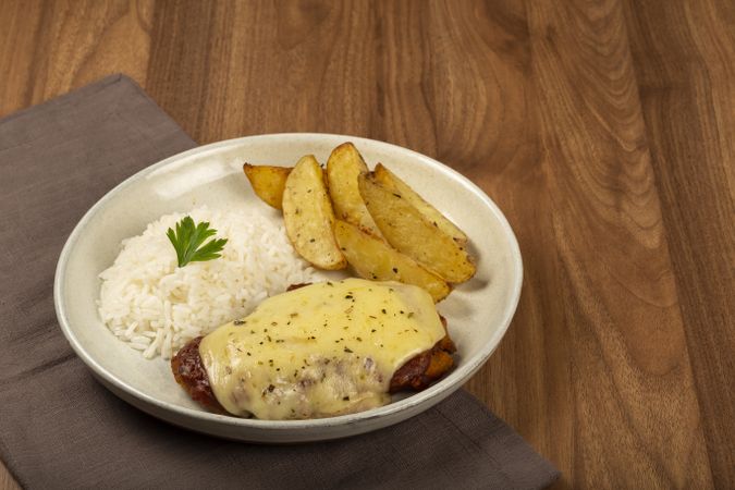 Parmigiana steak with rice and roasted potatoes. Typical Brazilian dish.