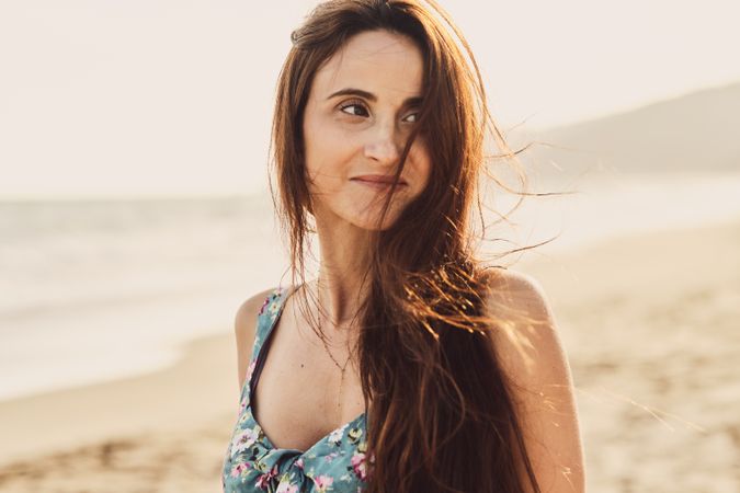Young woman in the beach at sunset