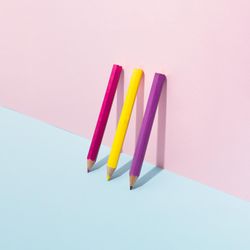 School pencils leaning on pastel background