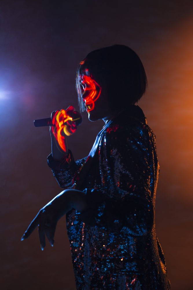 Stylish woman singing on stage
