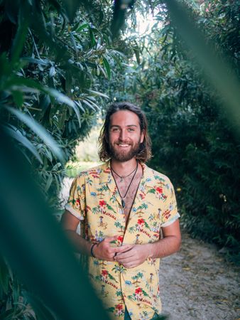 Hipster man walking in the jungle
