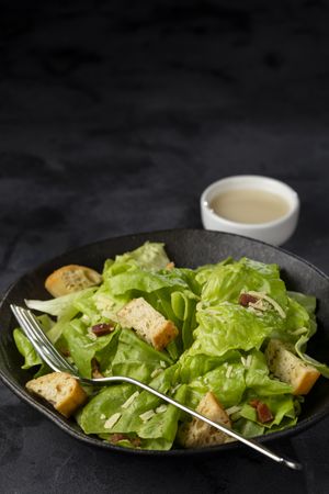 Caesar salad with croutons and bacon.