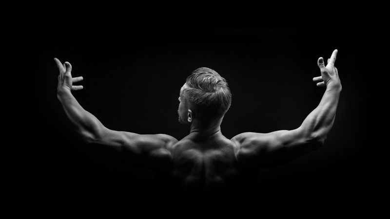 B&W studio shot of bodybuilders arms and shoulders