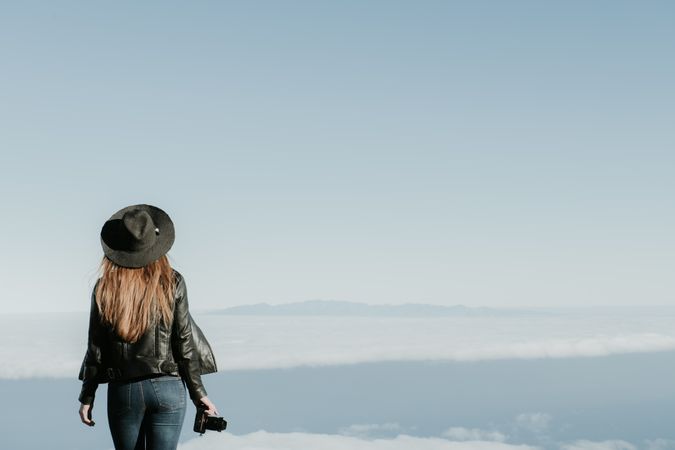 Woman with camera enjoying cloudscape