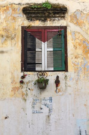 Retro window with flowerpots of old building