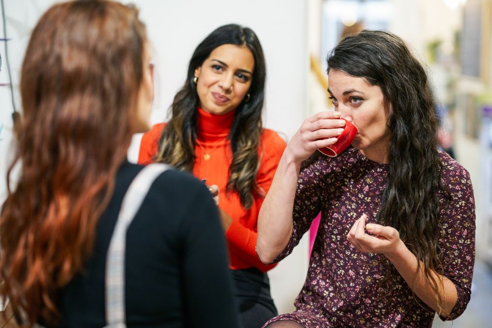 Women sipping coffee with her friends