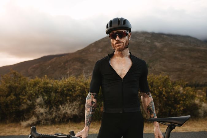 Cyclist completely equipped in professional outfit training outdoors