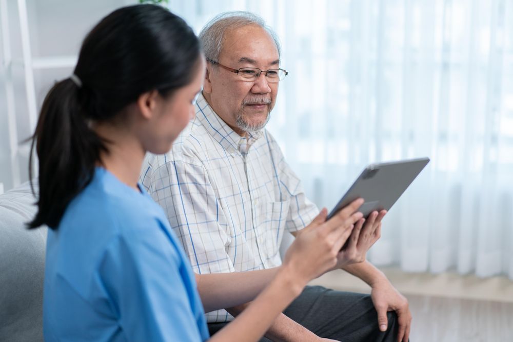 Nurse visiting patient with chart