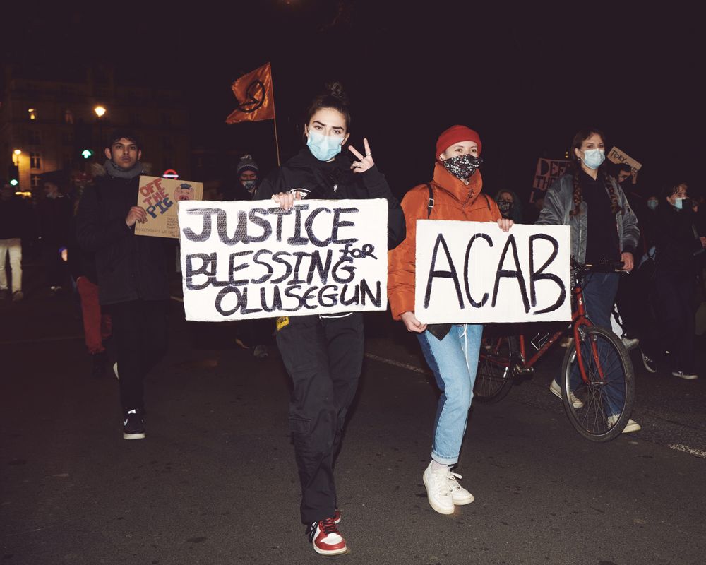 London, England, United Kingdom - March 16, 2021: Two women holding protest signs during march