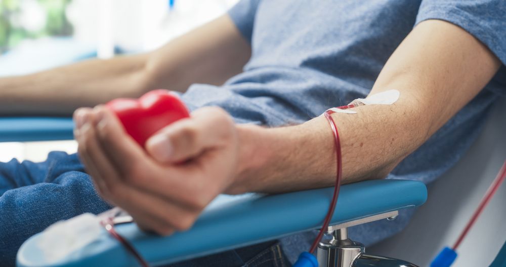 Close Up Shot Of Hand Of Male Blood Donor With an Attached Catheter.