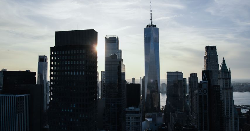 Moody Aerial New York City Evening View of Lower Manhattan Architecture. Panoramic Downtown Shot from a Helicopter at Sunset. Cityscape with Modern Office Buildings and Historic Skyscrapers