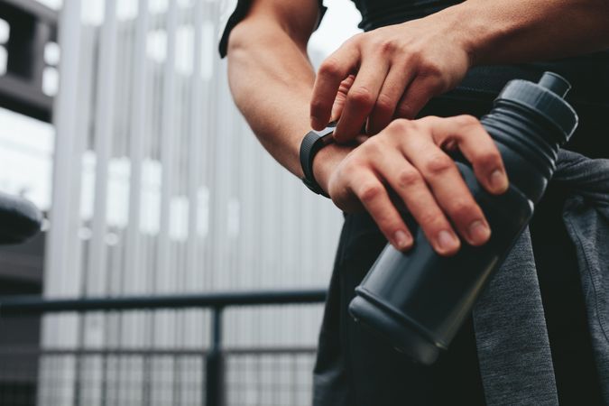 Male using a smart watch to monitor his progress
