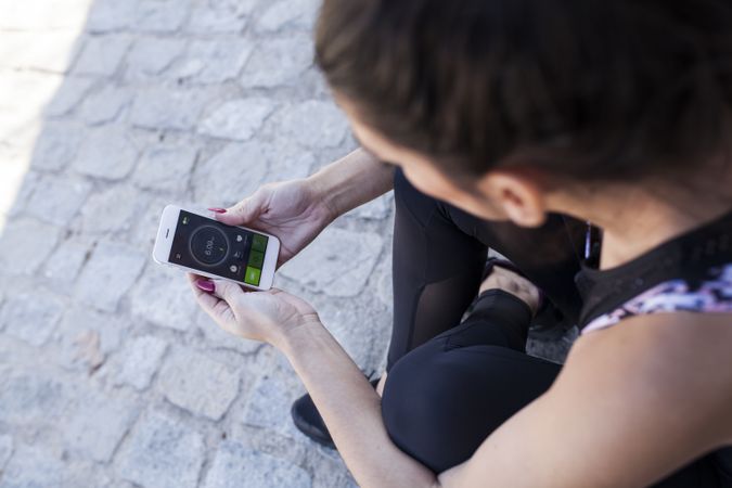 Woman using smartphone in sunny day