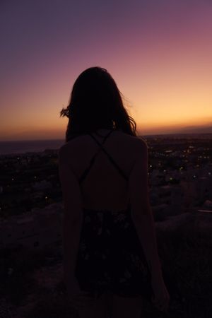 Silhouette of female enjoying picturesque sunset