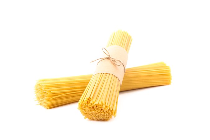 Pasta isolated on bright background. Uncooked whole wheat pasta