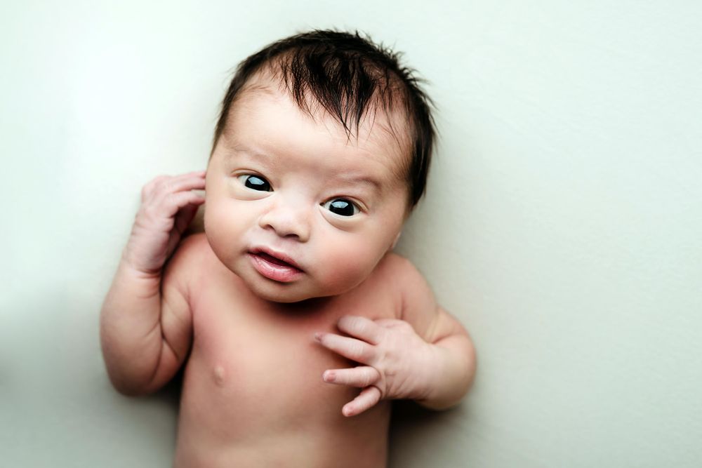 Portrait of newborn baby on light textile