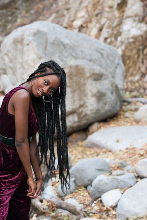 Black woman with box braids with boulders in background