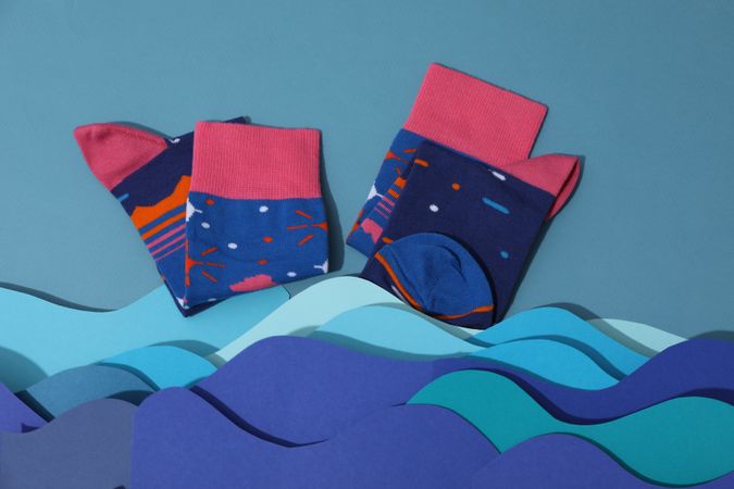 Casual clothes and wearing concept - socks, clothes for foot