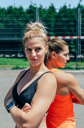 Sportswomen posing with crossed arms