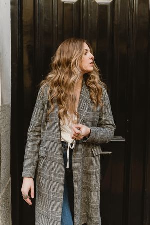 Woman standing near door on street